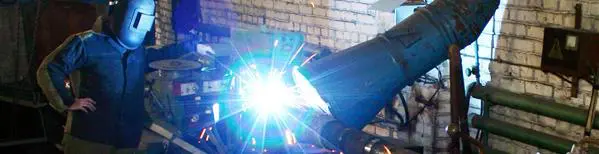 A person welding with a bright light shining on them.