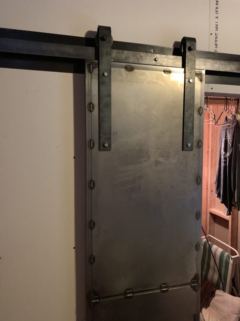 A metal door with some clothes hanging on it