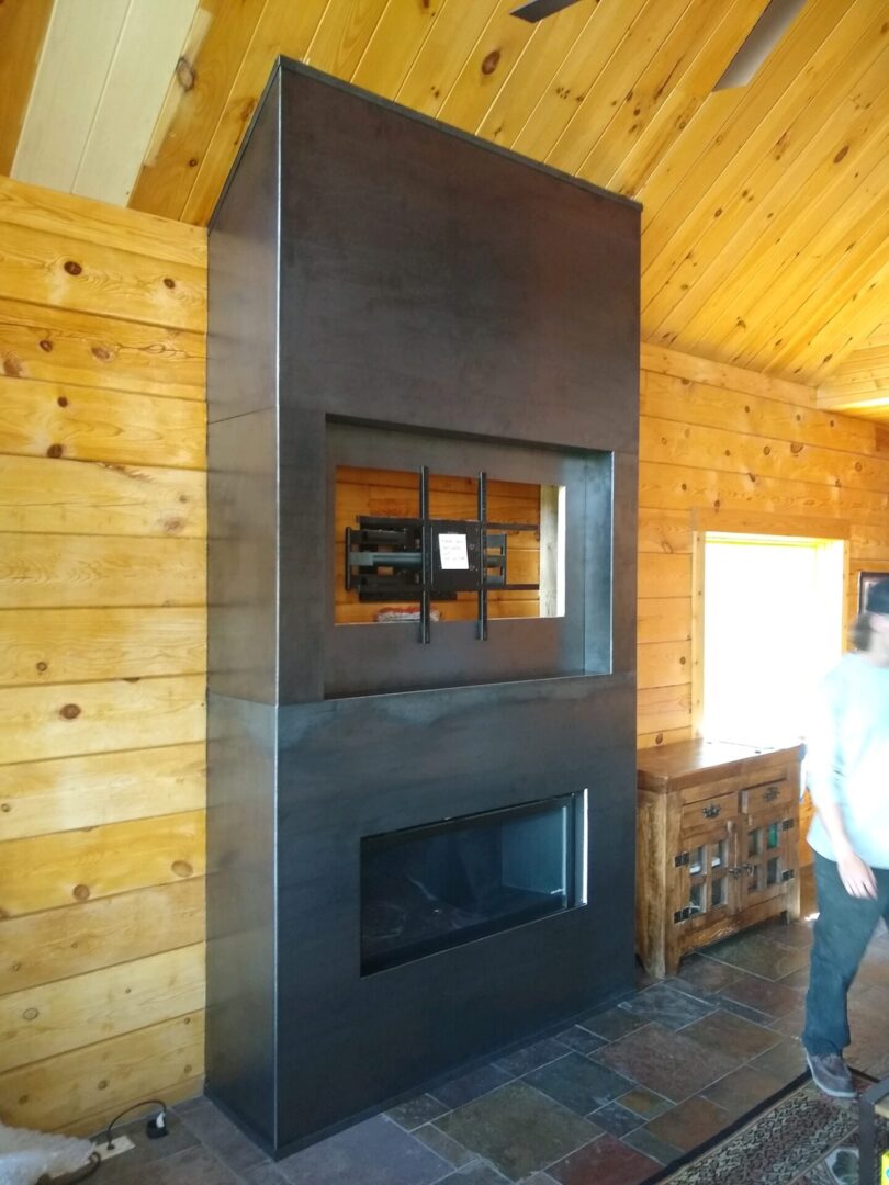 A fireplace with a television mounted on it.