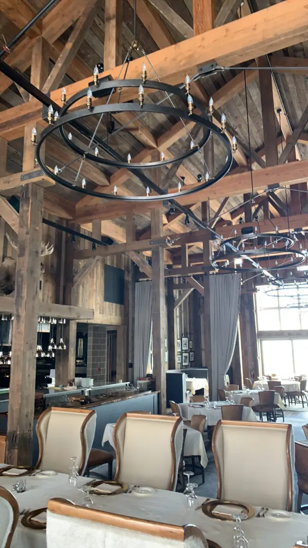 A large room with lots of wooden beams and furniture.