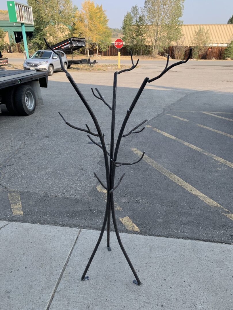A tree with branches on the ground in front of a truck.